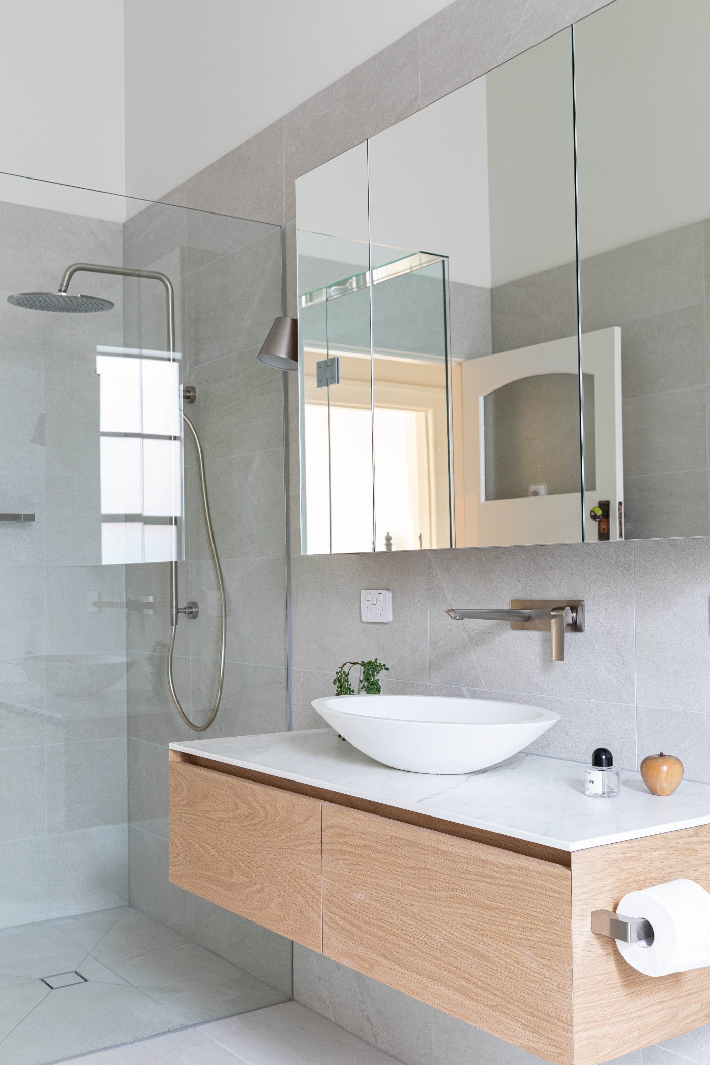 Bathroom with oak vanity and stone-tiled shower in a Camberwell addition