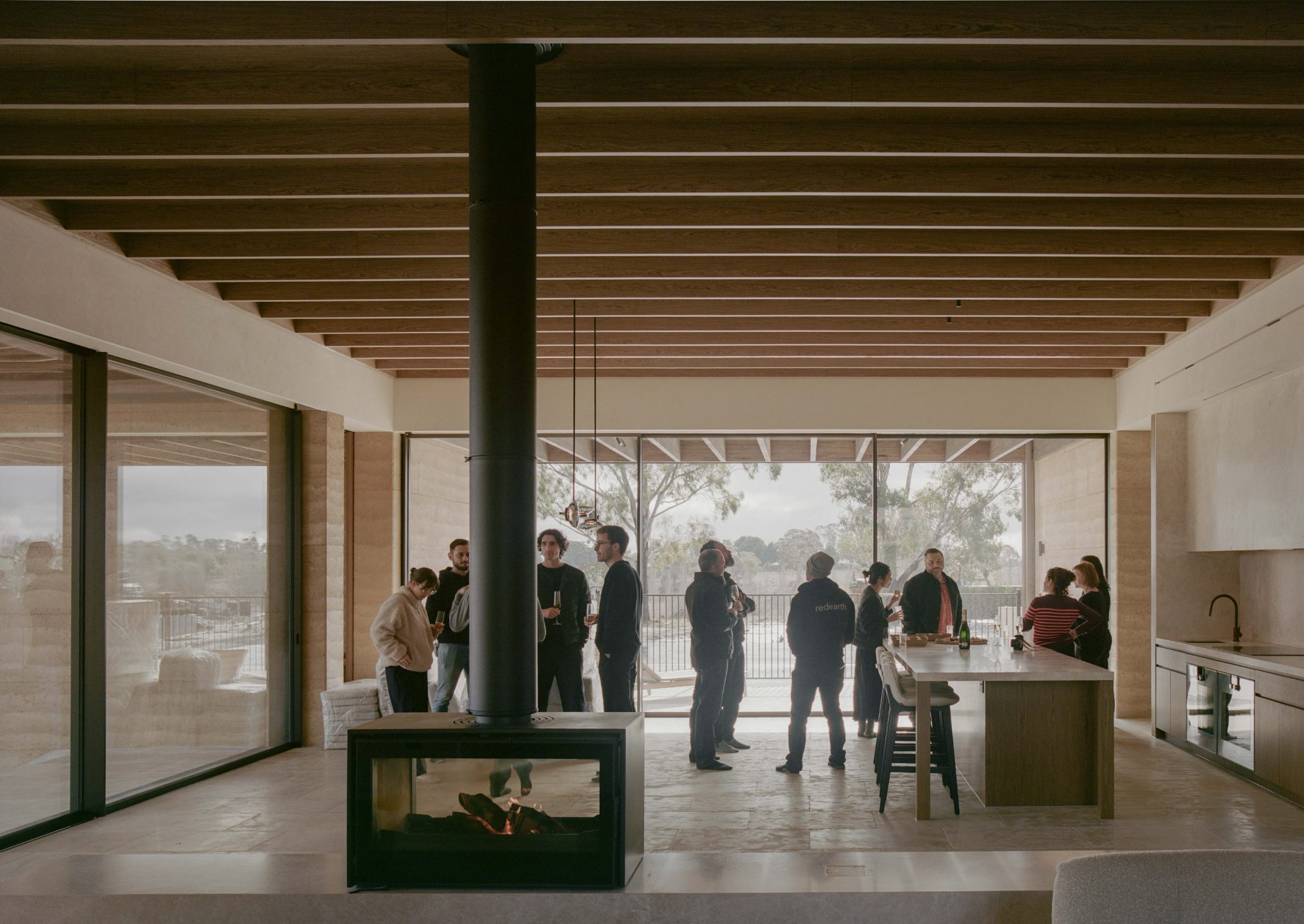 Clients and builders around the kitchen island of a completed home