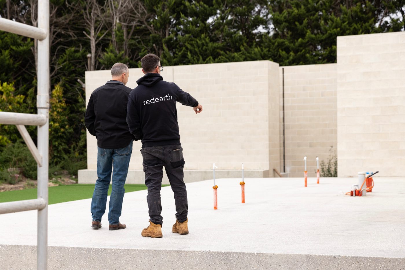 Builder walking a freshly finished concrete slab, Melbourne new build
